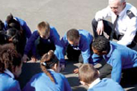 A teacher with children in a playground